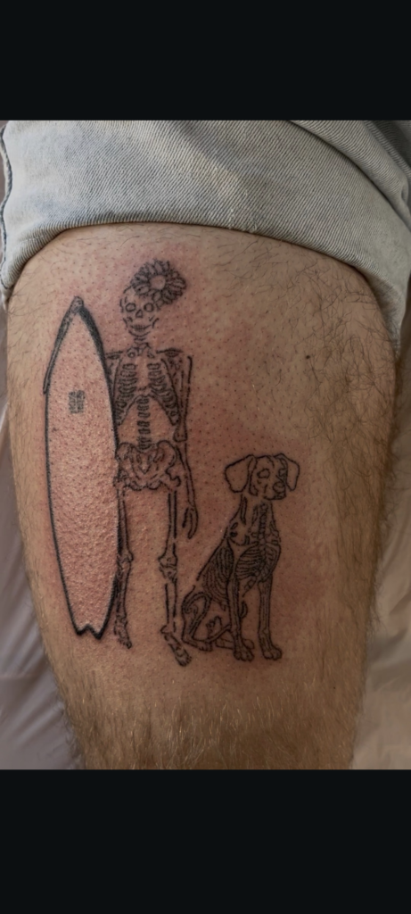 Skeleton human and dog with surfboard